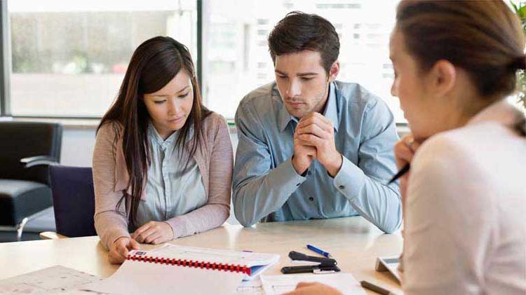 Couple doing an annual insurance review with their agent.