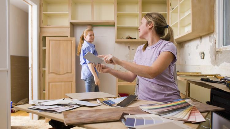 Women remodeling a kitchen and selecting colors.